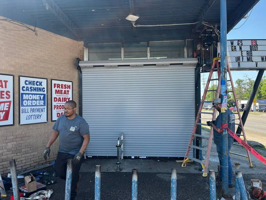 We Fix Garage Doors crew installing a commercial storefront roll-up door
