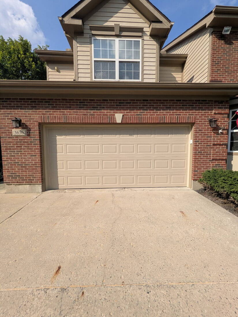 Tan garage door repaired and working after service
